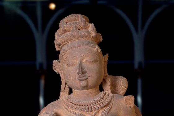 Figure of a Surasundari or divine beauty, wearing elaborate jewellery and with dressed hair, carved sandstone.